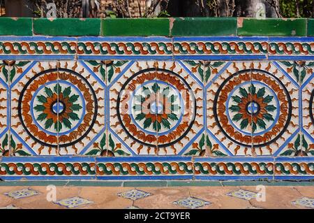 Azulejos, typical Spanish tilework decorating a bench in the Alcazar of Seville, Spain Stock Photo
