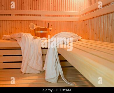 Germany, Aachen, sauna, wooden benches, bathrobes, brush and tub Stock Photo