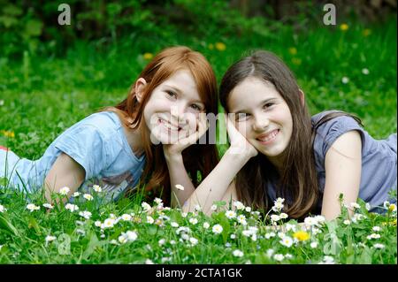 Girls are lying in a flower meadow Stock Photo