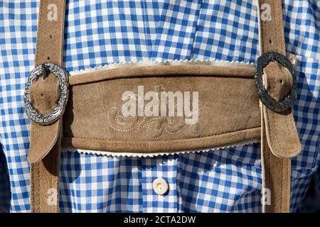 Germany, Bavaria, Munich, man at Oktoberfest wearing leather pants and chequered shirt, close up Stock Photo