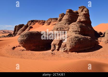 Algeria, Sahara, Tassili N'Ajjer National Park, rock towers in the sand dunes of Tin Merzouga Stock Photo