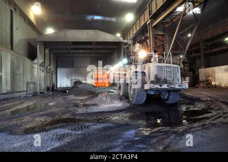Germany, Steel mill, removal of slag with shovel excavator Stock Photo