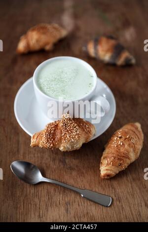 Mini croissants and cup of Matcha Latte Stock Photo