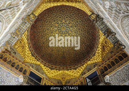 Hall of Ambassadors, Alcazar of Seville, Spain. Golden dome with geometric patterns and islamic muqarnas Stock Photo