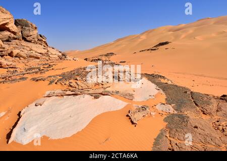 Africa, Algeria, Sahara, Tassili N'Ajjer National Park, Tadrart, Sand dunes and sandstone rocks at Oued in Djerane Stock Photo