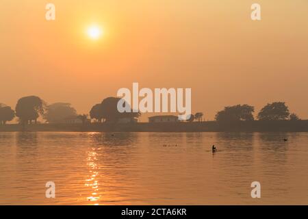 Brazil, Mato Grosso do Sul, Pantanal, Cuiaba River, Forest fire at sunrise Stock Photo