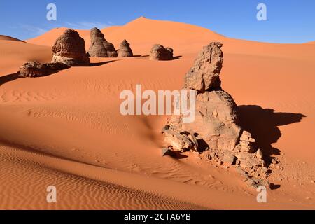 Algeria, Sahara, Tassili N'Ajjer National Park, rock towers in the sand dunes of Tin Merzouga Stock Photo