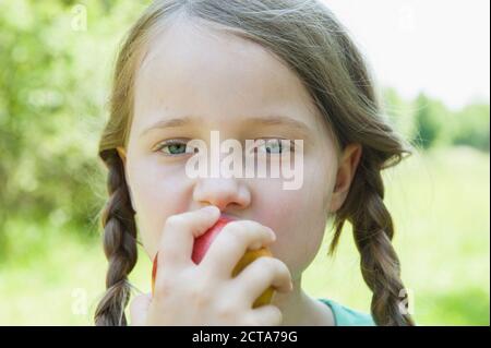 Germany, Bavaria, girl eating apple Stock Photo