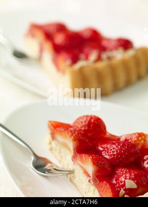 Two pieces of strawberry cake on dishes Stock Photo