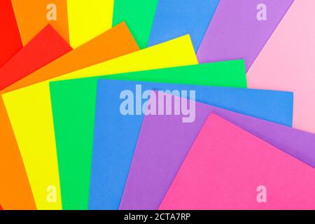 An abstract geometric textured background of multicolored rainbow colors created with overlapping foam craft paper Stock Photo