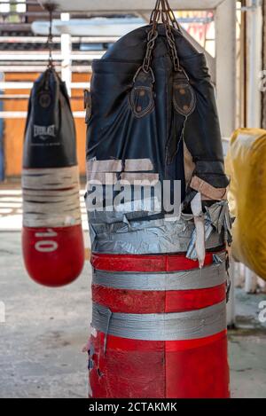 September 4, 2019: Dirty and torn punching bags in a boxing school. Havana, Cuba Stock Photo