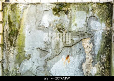 Texture of rough concrete or cement surface with stains of black paint and dirt. Old ruined surface of cityscape Stock Photo