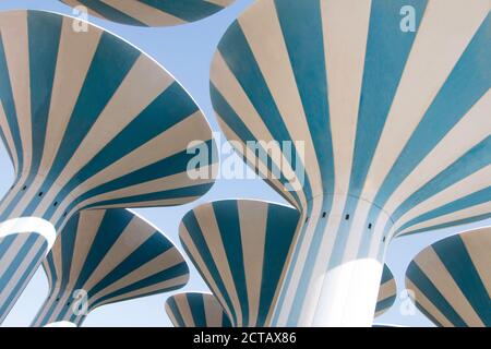 Iconic water towers in Kuwait, painted in blue and white stripes. Stock Photo