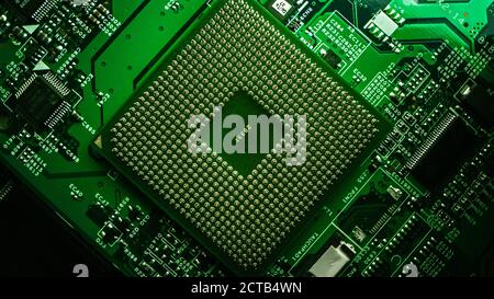 Macro Close-up Shot of CPU Processor Socket on Green Printed Circuit Board or Computer Motherboard with Components Inside of Electronic Device, Parts Stock Photo