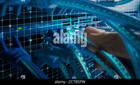 Macro Shot with Augmented Reality: IT Administrator Plugs in RJ45 Internet Connector into LAN Router Switch. Cables with Virtual Graphichs Showing Dat Stock Photo