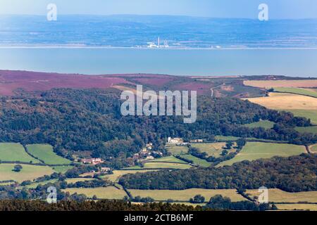 View from the summit of Dunkery Beacon (1,705ft) over the Bristol Channel and Selworthy village to Welsh coastline from Exmoor, Somerset, England, UK Stock Photo