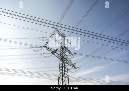 Power pole with many power cables in front of blue sky Stock Photo