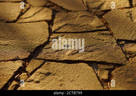 Brown wild stone road or pavement in sunny day. Stock Photo