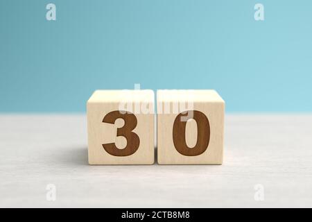 Wooden toy blocks forming the number 30. Stock Photo