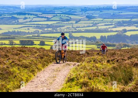 Mountain bikers approaching the summit of Dunkery Beacon – the highest point in Somerset  and Exmoor National Park(1,705ft), Somerset, England, UK Stock Photo