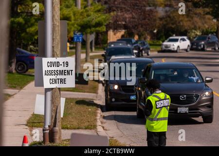 London, Canada - Sept, 21, 2020. Cars line up waiting upwards of three hours to be seen by public health screening nurses before proceeding for a COVI Stock Photo