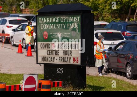 London, Canada - Sept, 21, 2020. Cars line up waiting upwards of three hours to be seen by public health screening nurses before proceeding for a COVI Stock Photo