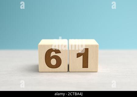 Wooden toy blocks forming the number 61. Stock Photo
