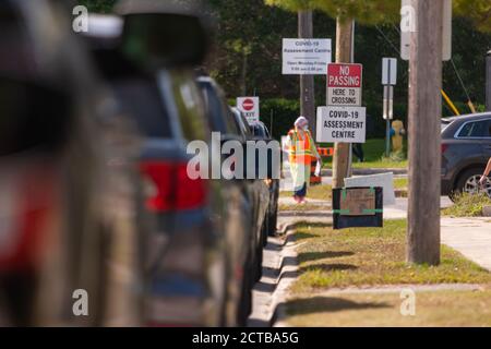 London, Canada - Sept, 21, 2020. Cars line up waiting upwards of three hours to be seen by public health screening nurses before proceeding for a COVI Stock Photo