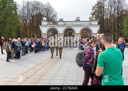 Warsaw, Poland - October 19, 2019: Tourists watch ceremony of changing the guard at the Tomb of Unknown Soldier in Warsaw on Pilsudski square Stock Photo