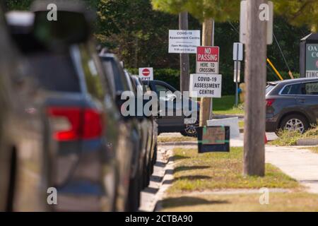 London, Canada - Sept, 21, 2020. Cars line up waiting upwards of three hours to be seen by public health screening nurses before proceeding for a COVI Stock Photo