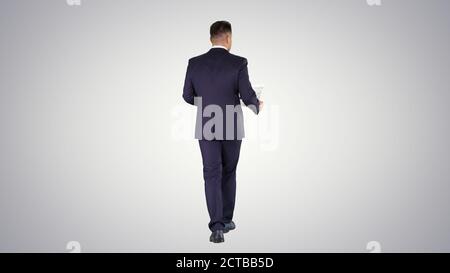 Businessman walking and supervising the plan of the house on gra Stock Photo
