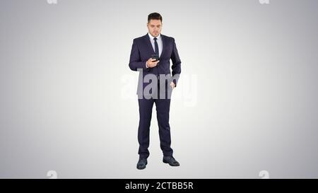 Serious worried businessman trying to call someone and can't get Stock Photo