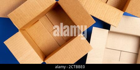 Empty open cardboard boxes on blue background. Top view Stock Photo