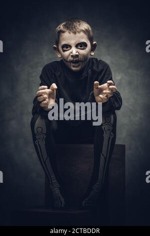 child dressed and made up as a skeleton for halloween party Stock Photo