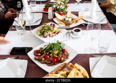 set table before start of anniversary celebration inside restaurant Stock Photo
