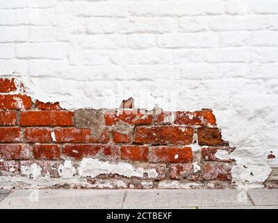 shabby red and white painted brick wall on Varvarka street in Moscow city Stock Photo