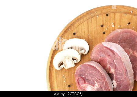 pieces of raw turkey meat, chopped leg steak, portioned barbecue pieces, on wooden board with rosemary, tomatoes and red hot pepper. isolate Stock Photo