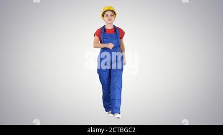 Confident experienced forewoman walking with will to work on gra Stock Photo