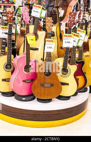 Phuket, Thailand - 26 February 2018: Guitars sale in music store. Musical instruments sold in shop Stock Photo