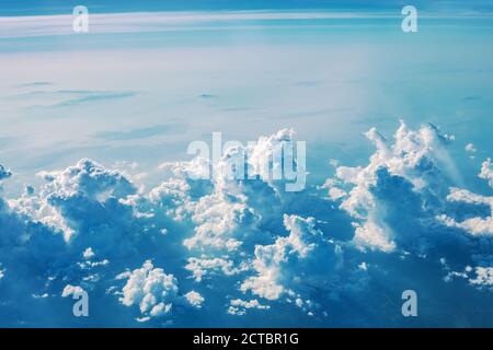 Cumulus storm clouds in blue sky with copy space. Beautiful summer landscape with cloudy skyline, aerial view from flying airplane window Stock Photo