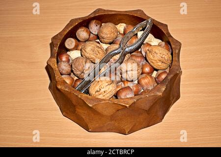 Almonds, walnuts and hazelnuts in wooden bowls on wooden background Stock Photo