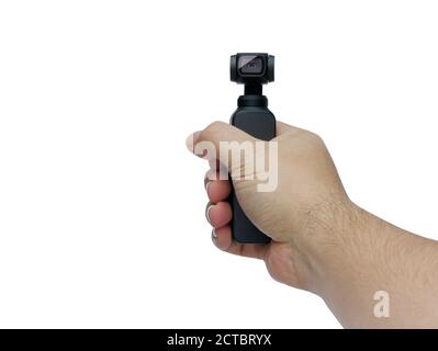Closeup hand manoeuvring and control little ccompact amera with gimbal isolated on white Stock Photo