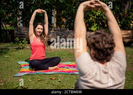 woman and man exercising outdoors Stock Photo