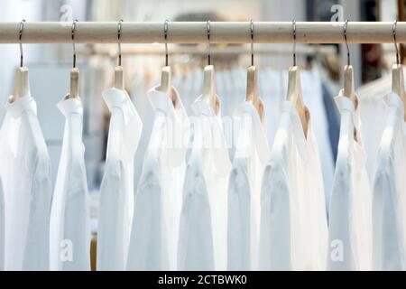 white shirt hanking on wood rack for decorated background Stock Photo