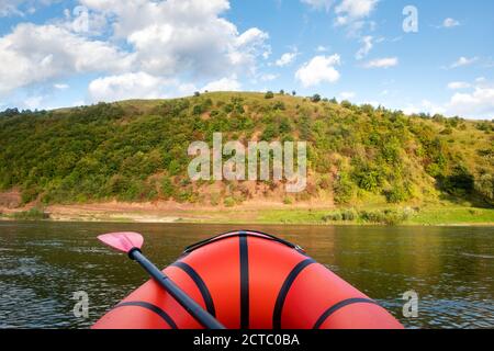 Orange packraft rubber boat on a river. Packrafting. Active lifestile concept Stock Photo
