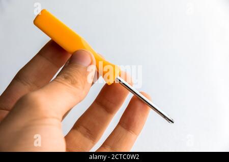 man of man that hold a screwdriver with handle rubber of red color on the white background Stock Photo