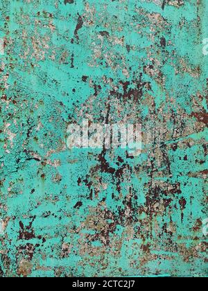 Corroded metal background. Rusted green cyan painted metal wall. Rusty metal background with streaks of rust. Rust stains. The metal surface rusted sp Stock Photo