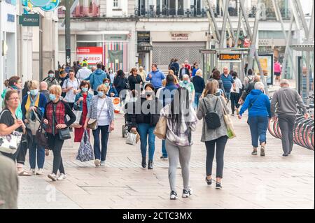 Cork, Ireland. 22nd Sep, 2020. People walk along Patrick Street in Cork city - some with face masks but most without. Cases of COVID-19 are on the increase across the country with fears more restrictions will be introduced. Credit: AG News/Alamy Live News Stock Photo