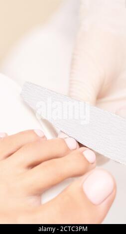 Classic pink wedding toe nail manicure on white backdrop. Spa treatment concept Stock Photo