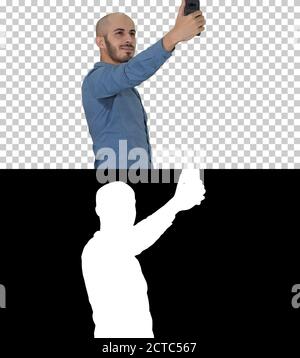 Selfie time! Handsome young man taking selfie with his phone, Al Stock Photo